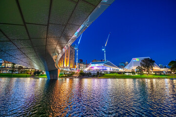 Adelaide night skyline along riverbank and Karrawirra Parri river, South Australia.