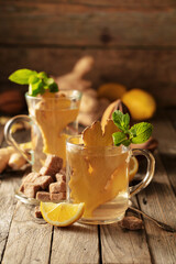 Ginger tea with ingredients on an old wooden table.