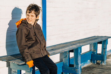 Autism awareness concept. Outdoor portrait of 10 years old autistic boy looking at camera.