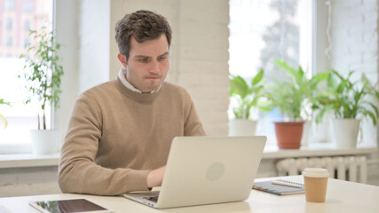 Man Feeling Disappointed While using Laptop