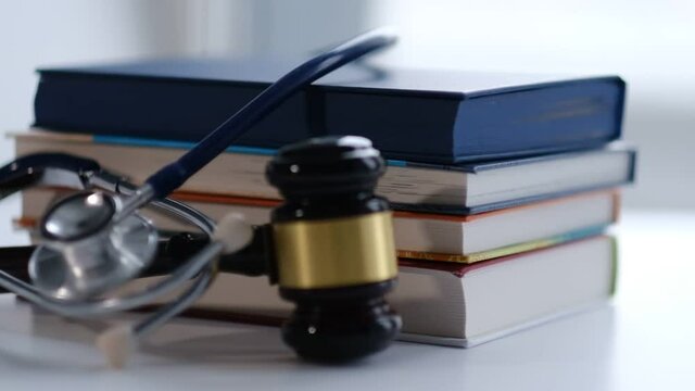 Gavel and stethoscope. medical jurisprudence. legal definition of medical malpractice. attorney. common errors doctors, nurses and hospitals make. Close-up shooting stock footage. slow motion