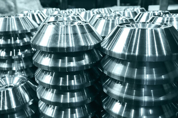 Carbide steel products turned on a milling machine are stacked in even piles. Close-up. 