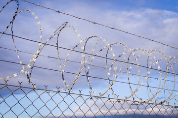 NATO barb wire with sharp and dangerous razor blades at a state border in europe	