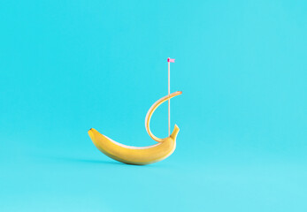 Exotic fruit against bright blue background. Creative summer layout, minimal sail boat, relaxing...