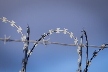 Closeup focus view of NATO barb wire with sharp and dangerous razor blades 