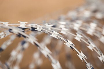 Closeup focus view of NATO barb wire with sharp and dangerous razor blades