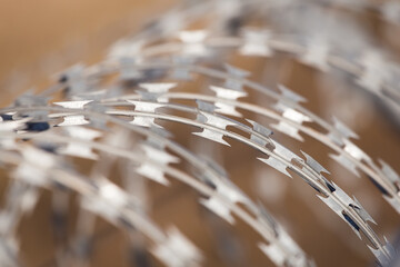 NATO barb wire with sharp and dangerous razor blades at a state border in europe	