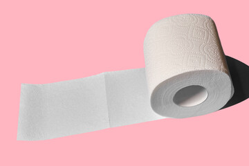 Toilet paper roll on a pink background. white soft roll unwound in the way of toilet paper.
