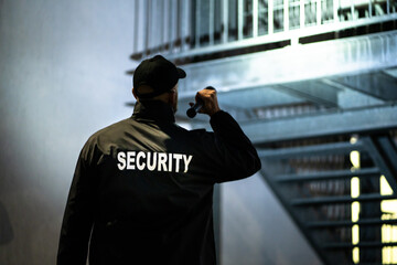 Security Guard Walking Building Perimeter - obrazy, fototapety, plakaty
