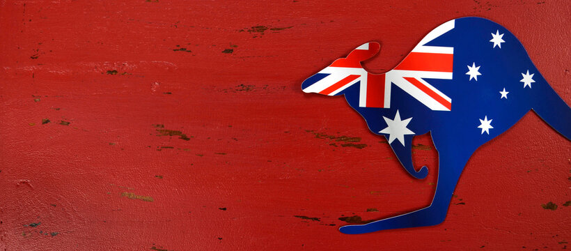Australia Day background with kangaroo shape Australian flag on red rustic recycled wood background, ized to fit a popular social media or web cover image banner.