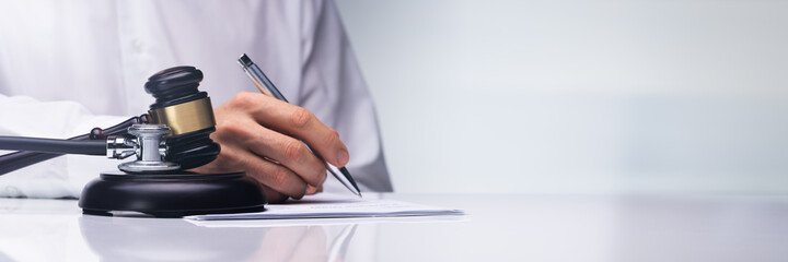 Judge Writing Criminal Order In Courtroom
