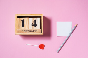 Empty picture frame and wooden date calendar with two red ribbons on purple background. Creative and cool celebration of love concept