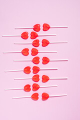 Heart shaped lollipops on purple background