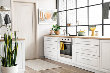 Fototapeta Interior of modern kitchen with white counters, door and peg boards obraz