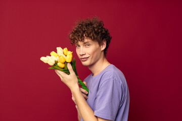 teenager holding a yellow bouquet of flowers purple t-shirts isolated background unaltered