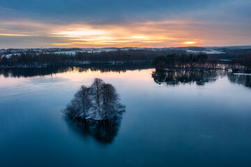 Aerial landscape of a wintery lake at sunset. Poland
