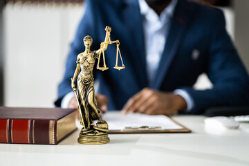 Midsection Of Judge Reading Documents At Desk
