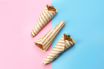 Tasty burritos on color background