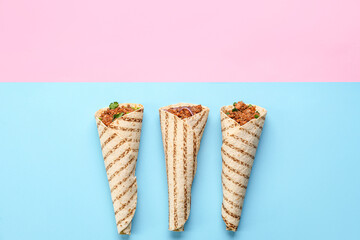 Tasty burritos on color background