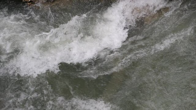 Rapid water stream with white foam. Mountain river, slow motion 180 fps