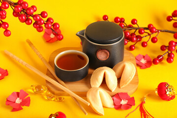 Traditional Chinese tea with cookies on color background