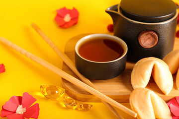 Traditional Chinese tea with cookies on color background