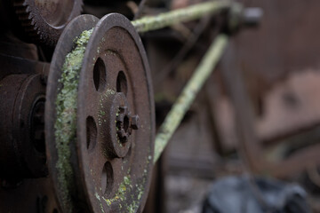 gears rollers of an old rusty motor on the farmyard