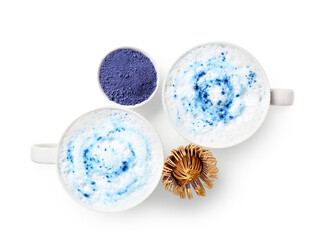 Cups of blue matcha latte, powder and chasen isolated on white background