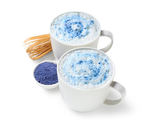 Cups of blue matcha latte, powder and chasen isolated on white background