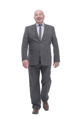 Mature business man striding forward .isolated on a white background.