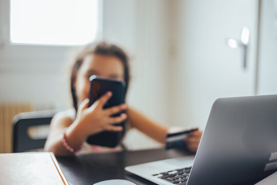Close up woman's hand using credit card and laptop for smartphones to buy online shopping