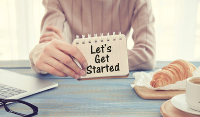 LET'S GET STARTED text concept write on notebook with office tools