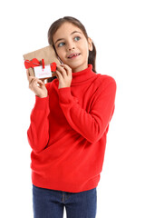 Funny little girl with gift on white background. Valentine's Day celebration