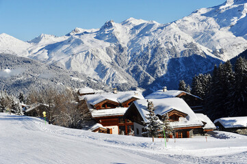Courchevel ski resort village in winter with Mont Blanc mountain behind 