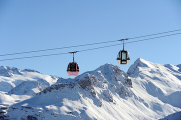 Fototapeta na wymiar Vintage ski gondolas of Courchevel ski resort Rhône alps, France by winter 