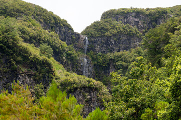 Fototapeta na wymiar Spectacular double waterfall falling through jungle forest.