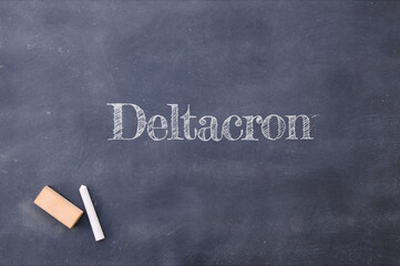 Deltacron written on a blackboard. Mix of Delta and Omicron variants