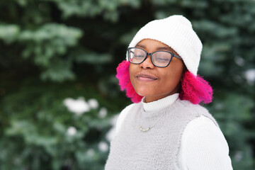 Portrait of beautiful happy girl young black African Afro American woman in cold sunny day at...