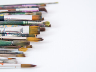 many different brushes for painting, artist's working brushes close-up, copy space