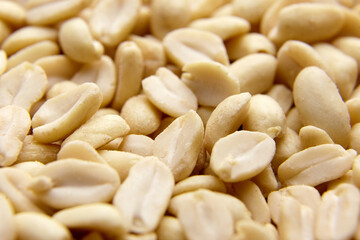 Raw blanched peanuts as food background