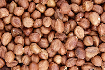 Shelled raw hazelnuts background closeup