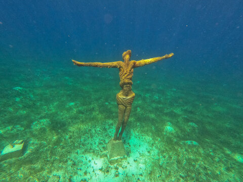 Underwater statue of Jesus Christ off the coast of Cozumel, Mexico in Quintana Roo. The religious statue is a popular sight for scuba divers and tourist snorkelers on vacation.