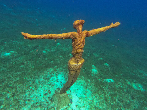 Underwater statue of Jesus Christ off the coast of Cozumel, Mexico in Quintana Roo. The religious statue is a popular sight for scuba divers and tourist snorkelers on vacation.
