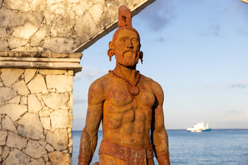 Monument of two cultures. Statue featuring Mayan warrior on the Cozumel, Mexico waterfront