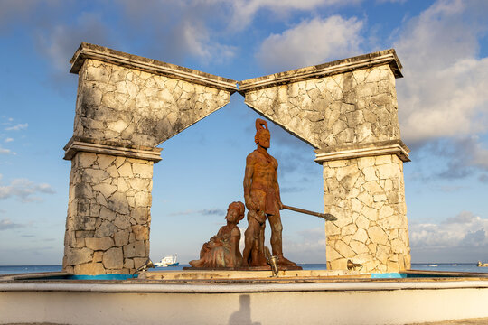 Monument of two cultures. Statue featuring Mayan warrior on the Cozumel, Mexico waterfront