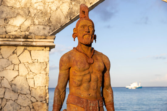 Monument of two cultures. Statue featuring Mayan warrior on the Cozumel, Mexico waterfront