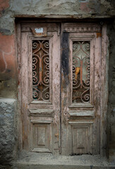 Fototapeta na wymiar Old vintage wooden doors in old Tbilisi. Facades of stone houses.