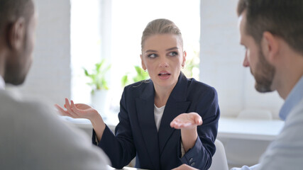 Angry Businesswoman Scolding Male Colleagues