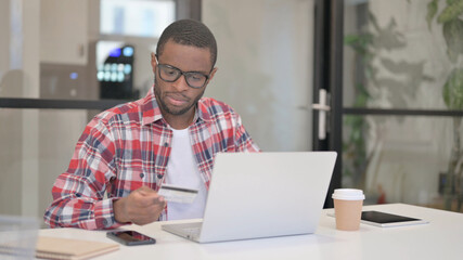 African Man Shopping Online on Laptop