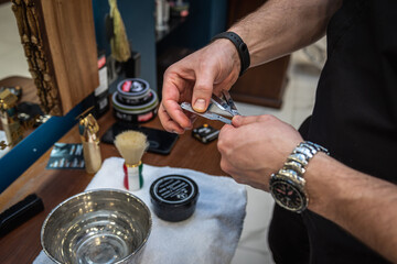 Men's hairdresser wooden desktop with shaving tools. Preparing the blade for shaving before shaving